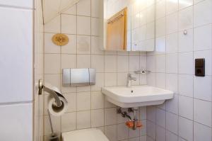a bathroom with a toilet and a sink at Enderle in Uhldingen-Mühlhofen +13 photos