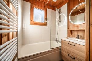 a bathroom with a shower and a tub and a sink at Chalet Des Charmes in Thollon +32 photos