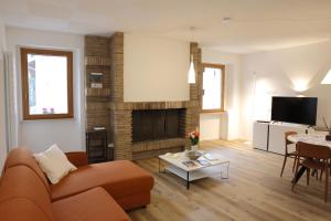 a living room with a couch and a fireplace at Appartamento Torricelli in Fossombrone