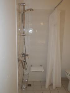 a bathroom with a shower and a toilet at Maison dans résidence mer - piscine in Loc-Maria-Plouzané +28 photos