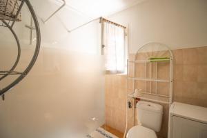 a bathroom with a toilet and a shower with a window at Isula Paradise in Linguizzetta +17 photos