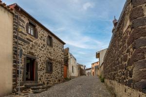 an alley in an old town with stone buildings at Antica dimora in Paulilatino