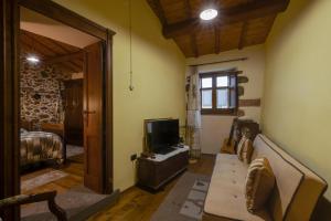 a living room with a couch and a television at Antica dimora in Paulilatino