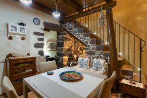 a dining room with a table and a stone wall at Antica dimora in Paulilatino