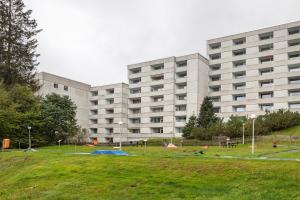 a large building with a park in front of it at Harz Stube in Goslar