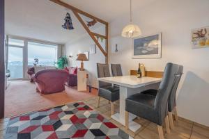a dining room and living room with a table and chairs at Harz Stube in Goslar