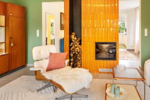 a living room with a chair and a fireplace at Dahlienhof in Wittenberge