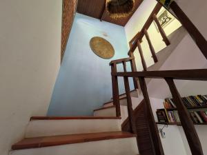 a staircase in a house with a book shelf at Pousada Manacá — Beachfront Guesthouse on Ilha Grande in Abraão