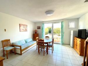 a living room with a couch and a table at La Maison sur la côte in Fleury