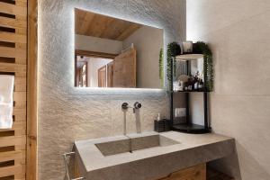 a bathroom with a sink and a mirror at Luxury Chalet Giulia in Torcegno +56 photos
