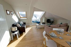 a living room with a couch and a table at 6 Little Beach in Woolacombe