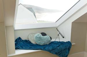 a room with two pillows on a shelf with a window at 6 Little Beach in Woolacombe