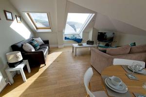 a living room with a couch and a table at 6 Little Beach in Woolacombe