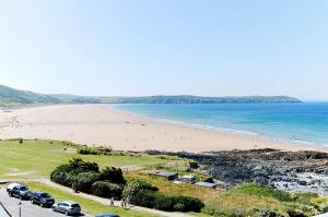 a beach with cars parked next to the ocean at 6 Little Beach in Woolacombe