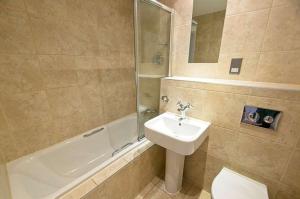 a bathroom with a sink and a toilet and a shower at 6 Little Beach in Woolacombe +13 photos