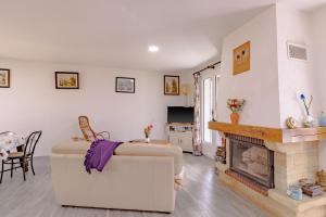 a living room with a couch and a fireplace at Maison Sur le Causse Corrézien in Saint-Cernin-de-Larche