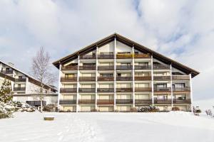 a large building with snow in front of it at Appartement Förster in Oy-Mittelberg