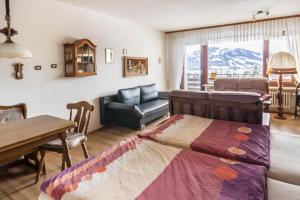 a bedroom with a bed and a table and a chair at Appartement Förster in Oy-Mittelberg