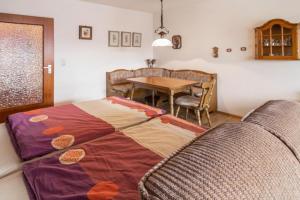 a living room with a table and a bed at Appartement Förster in Oy-Mittelberg +17 photos