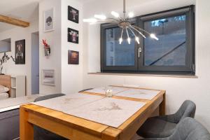 a dining room with a table and a window at Schwarzwald Chalet Achern in Achern +6 photos