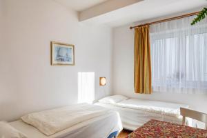a room with two beds and a window at Ferienwohnung Tannenblick 1-1 in Oberhof