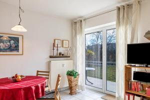 a living room with a table and a sliding glass door at Ferienwohnung Tannenblick 1-1 in Oberhof