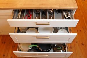 a kitchen drawer filled with dishes and utensils at Ferienwohnung im Hofratshaus in Schrozberg