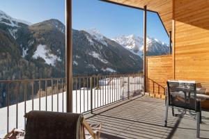a balcony with a view of a snowy mountain at Chalet-Suite Wiese in Selva dei Molini