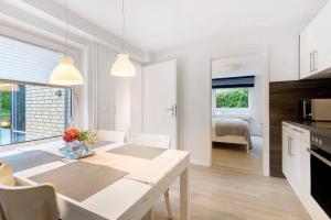 a kitchen and dining room with a table and chairs at Ferienwohnung Angeln in Ulstrupfeld +14 photos