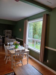 a dining room with a table and a window at Grumpy's Suite by the Lake in Summerland