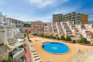 an apartment complex with a swimming pool in front of a building at Orlando 314 in Adeje
