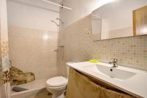 a bathroom with a sink and a toilet and a shower at Quinta do Castelo - Casa de Pedra in Reguengo Grande +20 photos