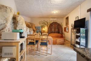 a kitchen with a table and a room with a stone wall at Quinta do Castelo - Casa de Pedra in Reguengo Grande