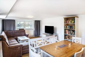 a living room with a couch and a table at Haus am Eschenbach in Lindenberg