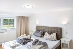 a bedroom with a bed with pillows on it at Haus am Eschenbach in Lindenberg
