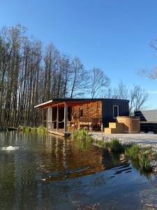 a cabin next to a body of water at Tiny house Františka in Klatovy