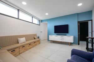 a living room with a couch and a flat screen tv at Villa Ker Marie in Locquirec