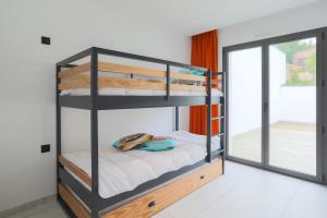 a bunk bed in a room with a window at Villa Ker Marie in Locquirec