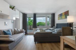 a living room with a couch and a table at Appartement Hella Wahnsinn in Sankt Englmar