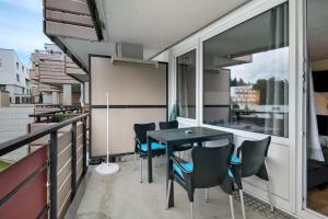 a balcony with a table and chairs on a building at Appartement Hella Wahnsinn in Sankt Englmar