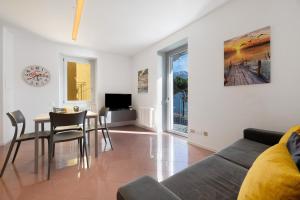 a living room with a couch and a table at Lake view Domaso in Domaso