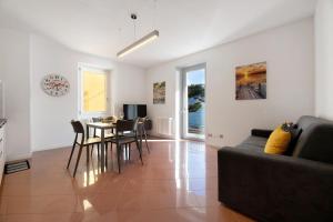 a living room with a couch and a table at Lake view Domaso in Domaso
