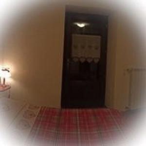 a room with a door and a bed and a lamp at Maison Perruchon in Pont-Saint-Martin