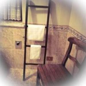 a towel rack in a bathroom with towels on it at Maison Perruchon in Pont-Saint-Martin