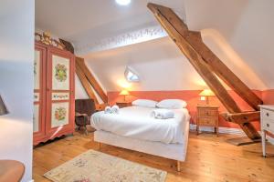 a bedroom with a bed with white sheets and pillows at Magnifique maison à Ribérac in Ribérac +30 photos