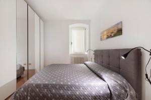 a bedroom with a bed in a white room at Lake view Domaso in Domaso