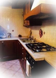 a kitchen with a stove and a sink at Maison Perruchon in Pont-Saint-Martin