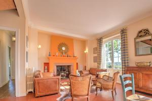 a living room with a fireplace and a table and chairs at Magnifique maison à Ribérac in Ribérac