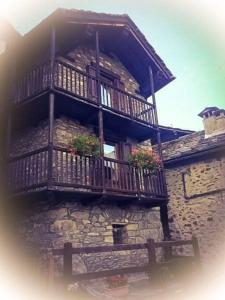 a building with a balcony with flowers on it at Maison Perruchon in Pont-Saint-Martin