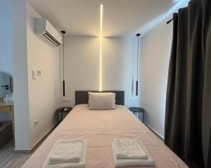 a bedroom with a bed with two towels on it at Central -III- Room in Athens